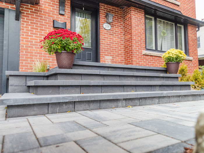 A complete redesign featuring custom stonework, accent pavers, and curated planting beds to elevate curb appeal