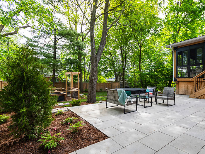 Natural textures, tiered spaces, and thoughtful details bring structure and serenity to this modern outdoor retreat