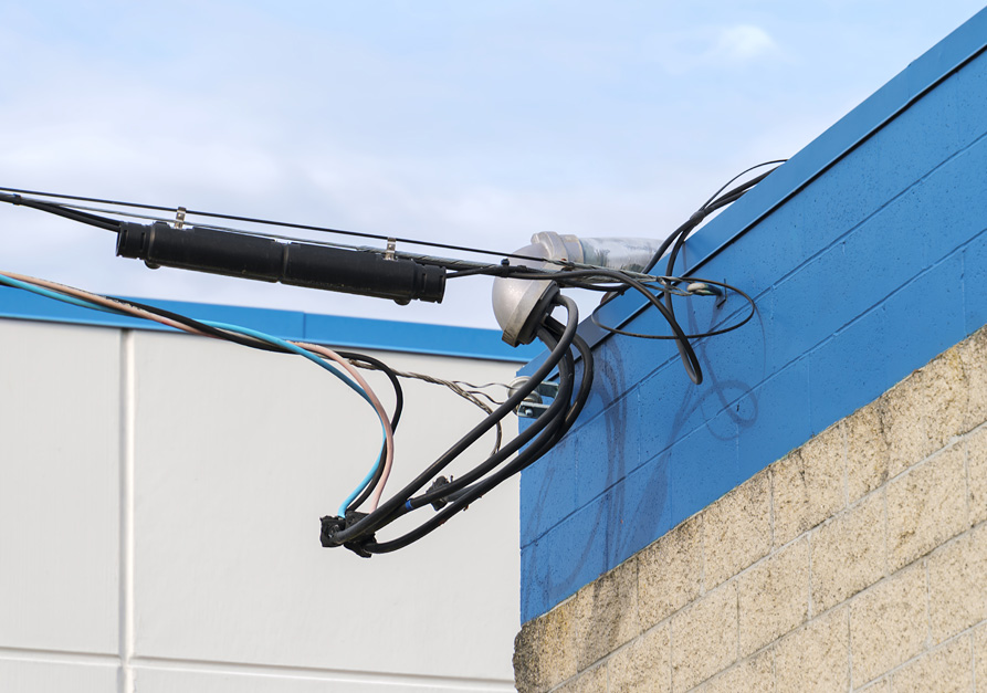 Close-up of electrical service mast on a commercial building